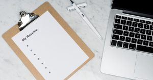 Professional reviewing ATS-optimized resume on laptop