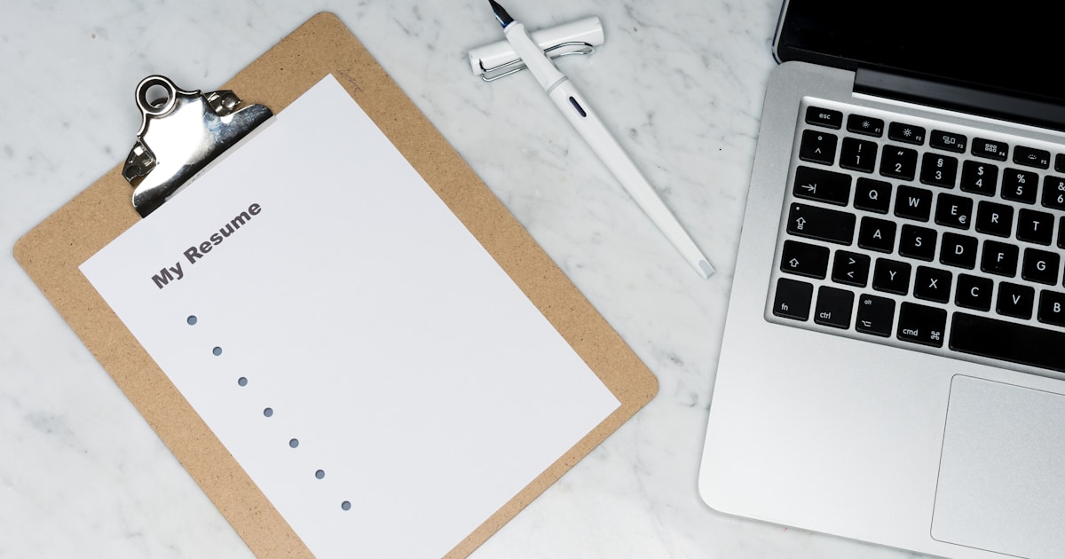 Professional reviewing ATS-optimized resume on laptop