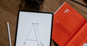 Professional optimizing LinkedIn profile on laptop to attract recruiters