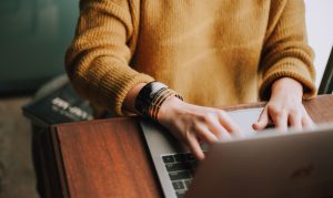 Person writing a resume objective statement at a desk
